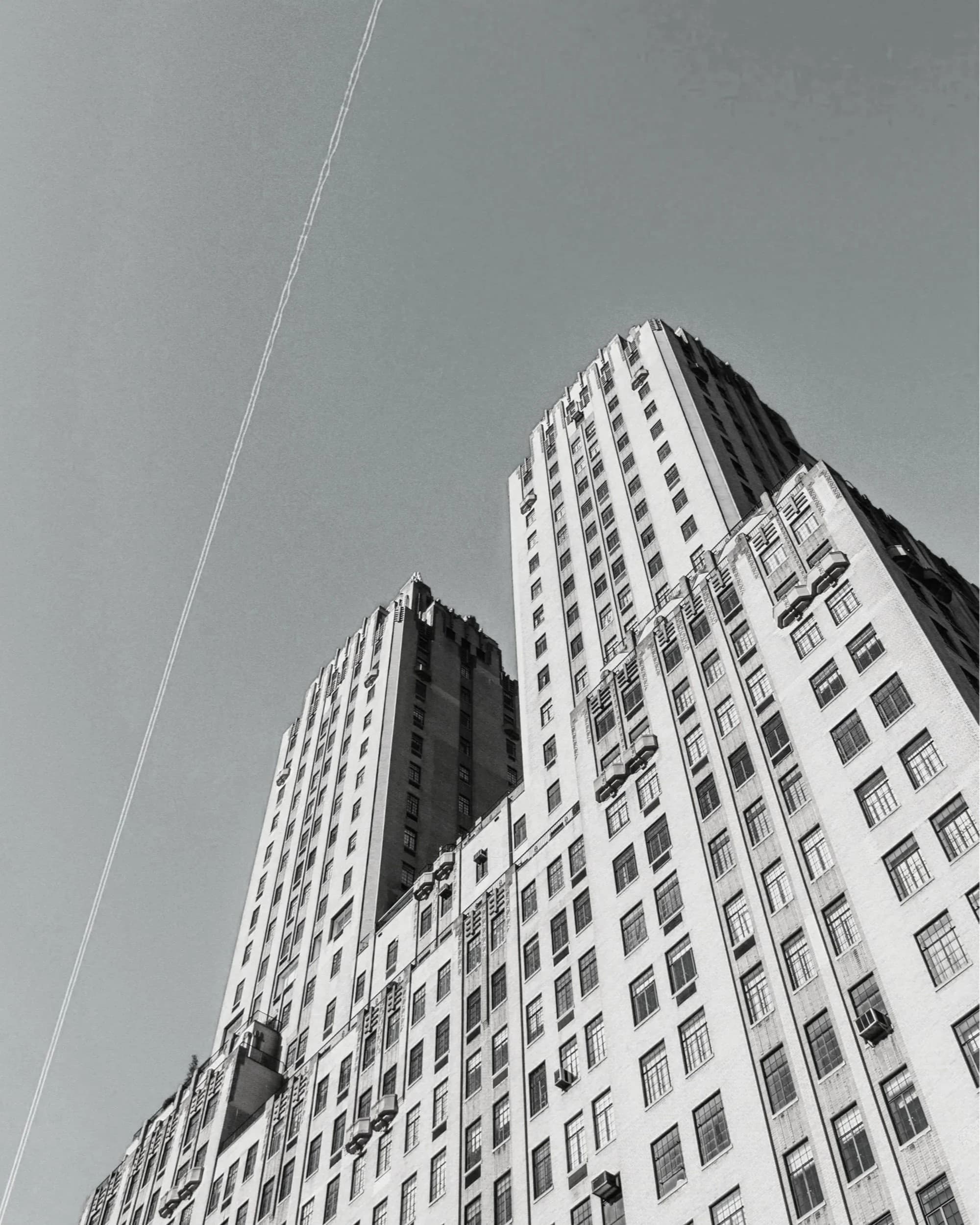 Black-and-white view up the facade of a prewar New York City building