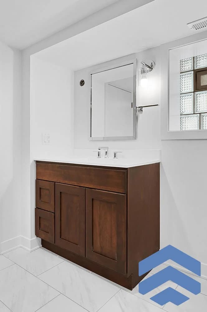 Basement bathroom with a new vanity and medicine cabinet installed