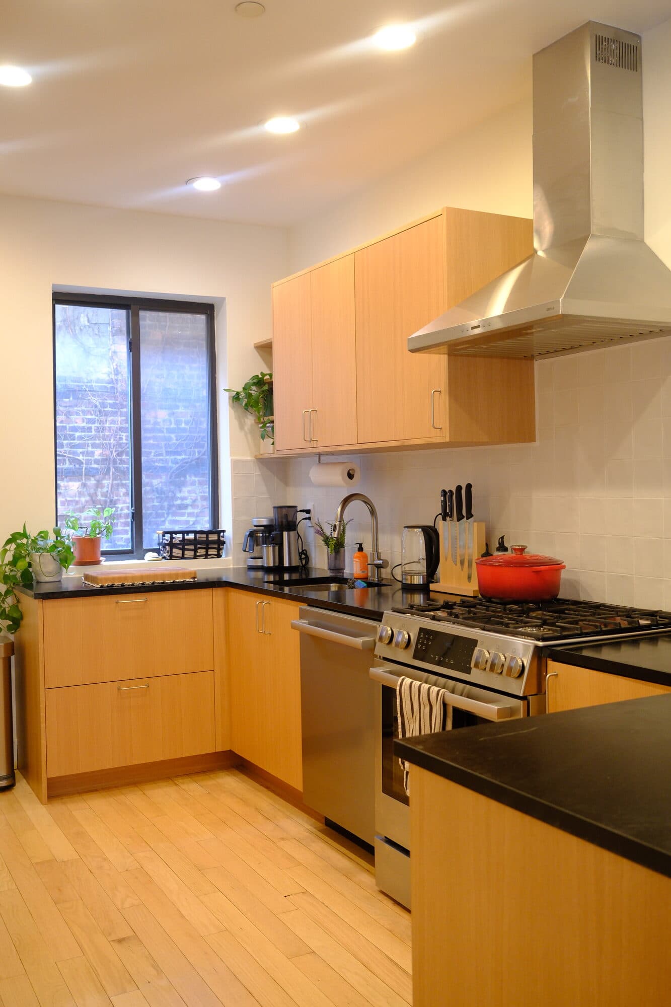 Brooklyn kitchen renovation with wood-paneled accent wall by Alpha