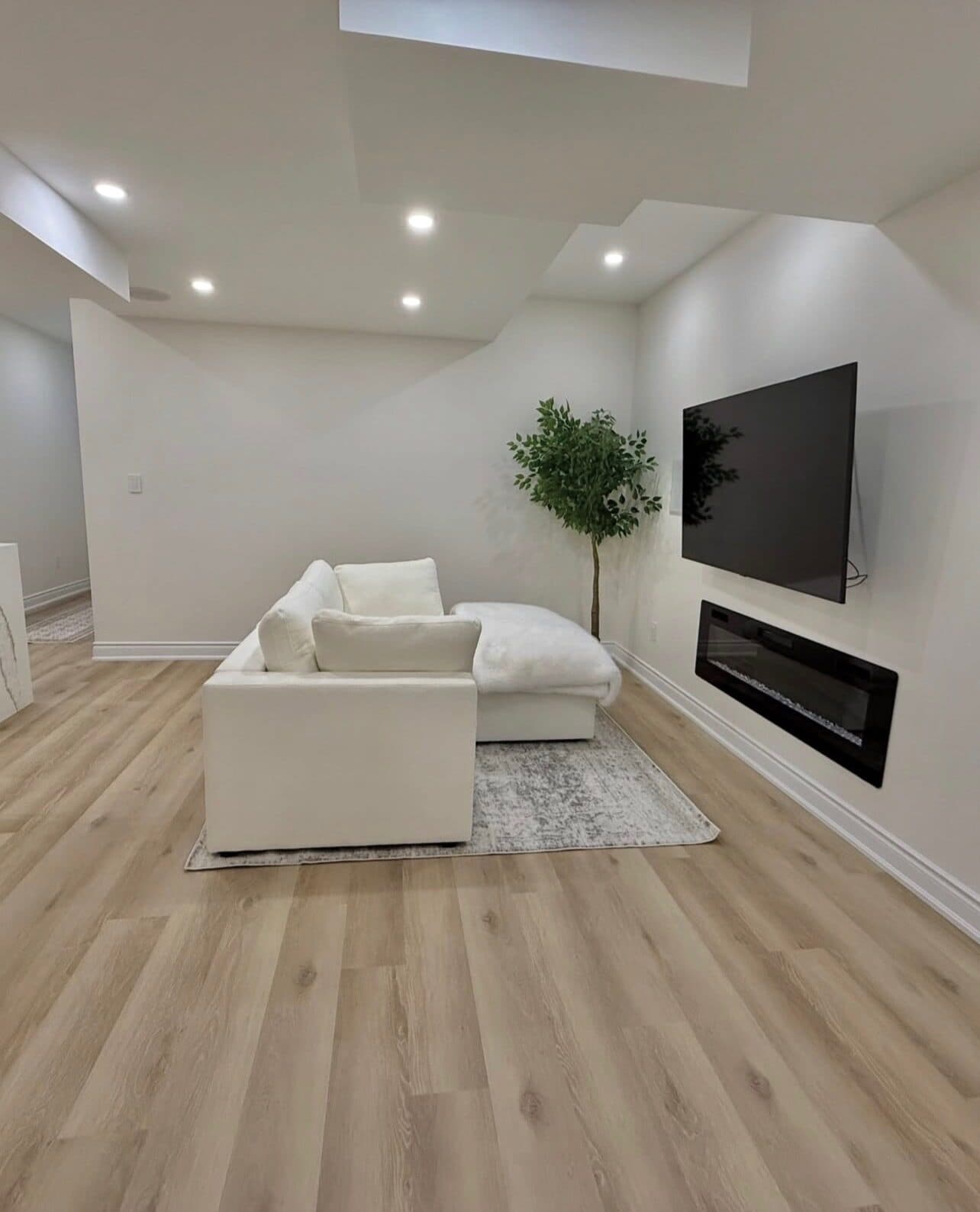 Den with linear fireplace in Alpha's FiDi apartment renovation