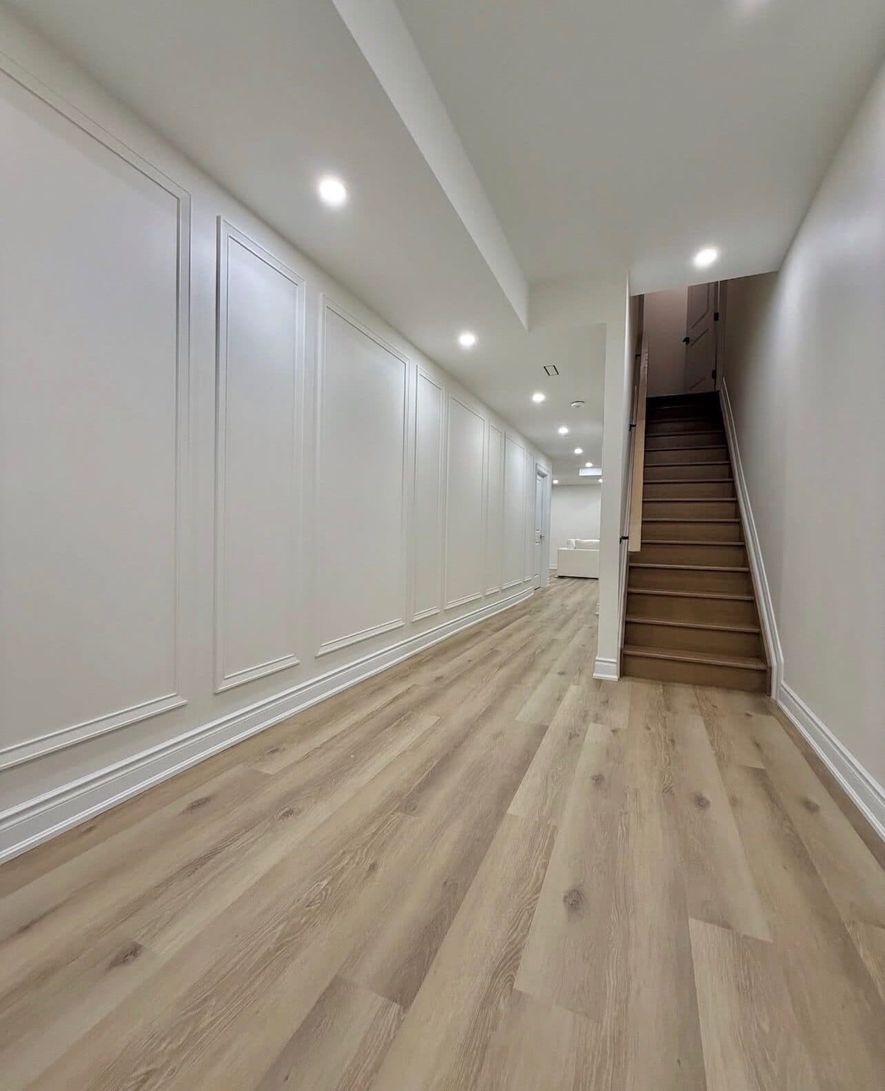 Hallway and staircase with wainscoting after the renovation