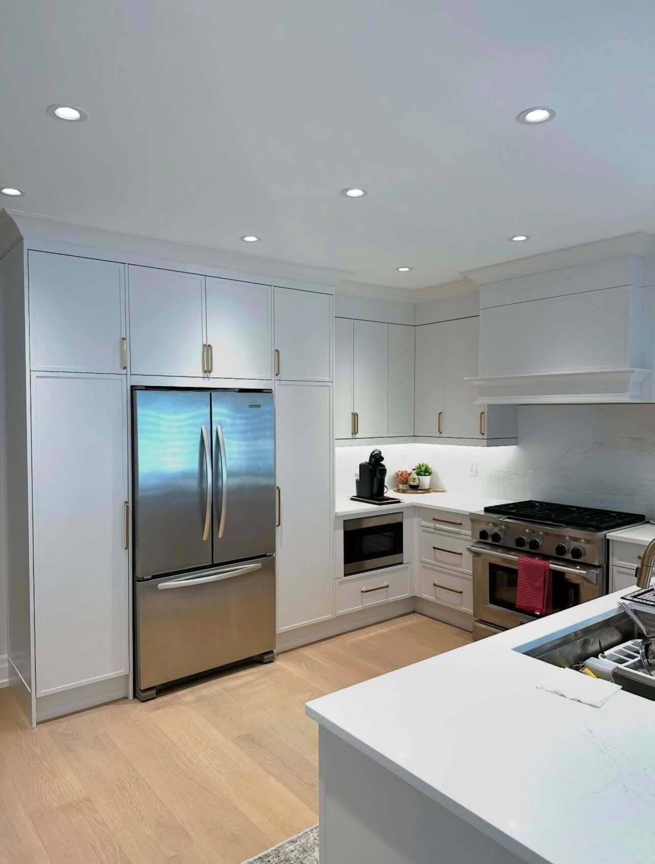 Prospect Heights kitchen with stainless refrigerator, island sink, and white oak flooring