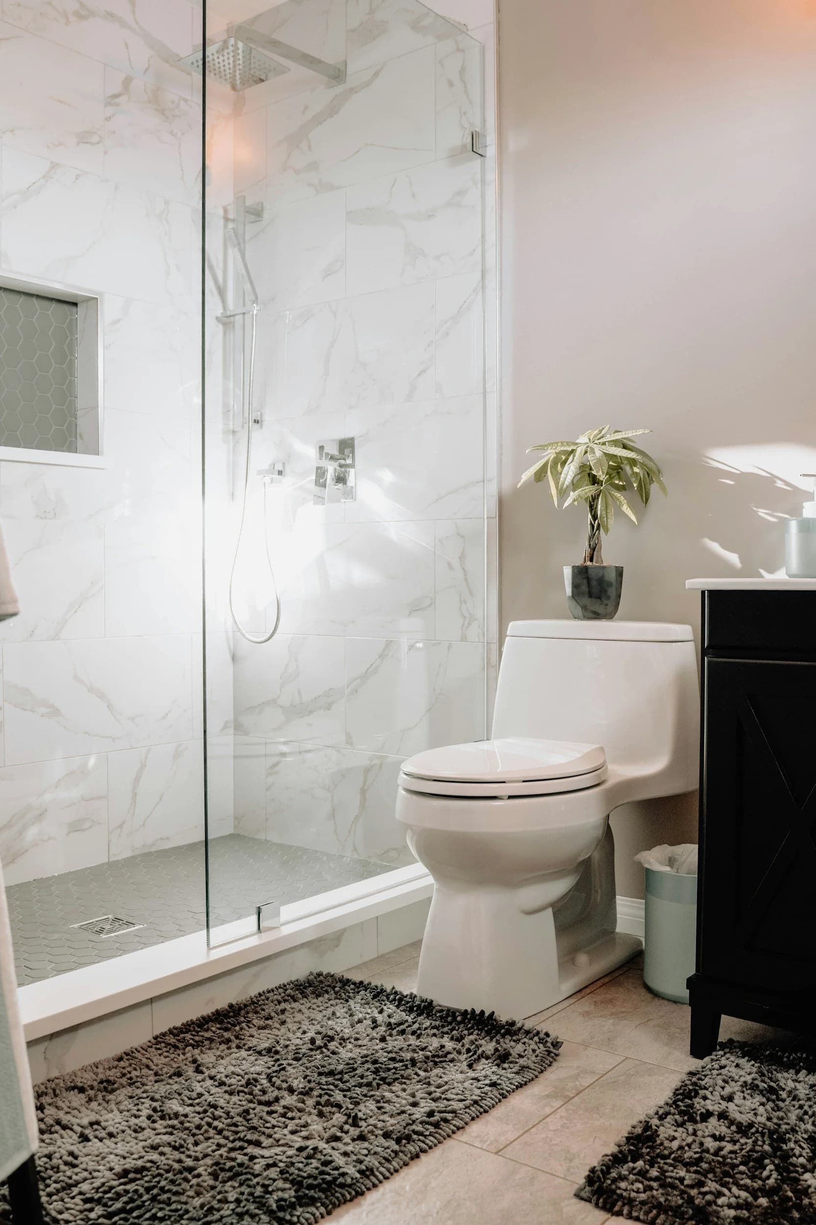 Bathroom renovation detail with polished tile, floating vanity, and layered lighting